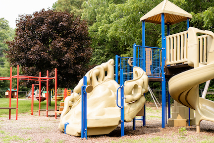 Playground with climbing apparatus, playhouses, swings.