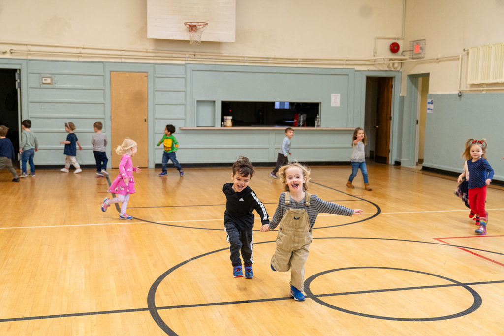 Playschool children playing in gym